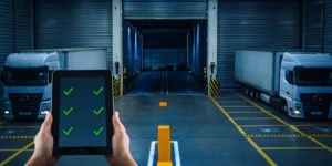 Person at a loading dock reviews a checklist for cross-docking services needed near me on a tablet.
